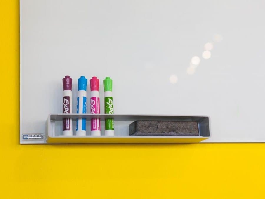 Whiteboard with a tray of coloured markers