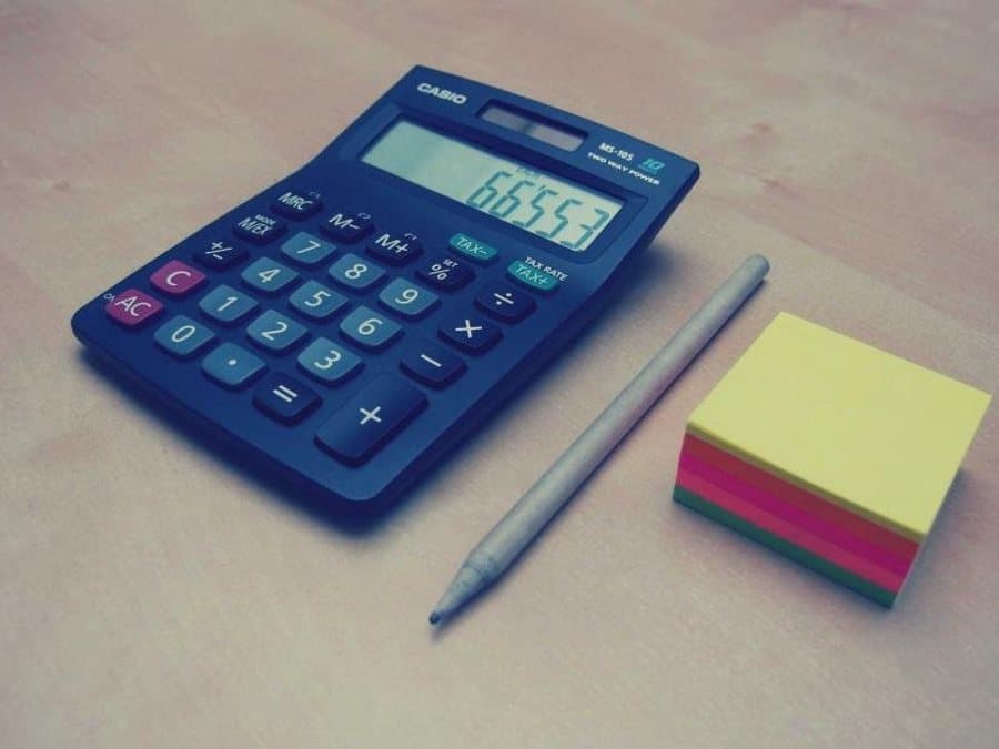 Desktop calculator with a pencil and sticky notes