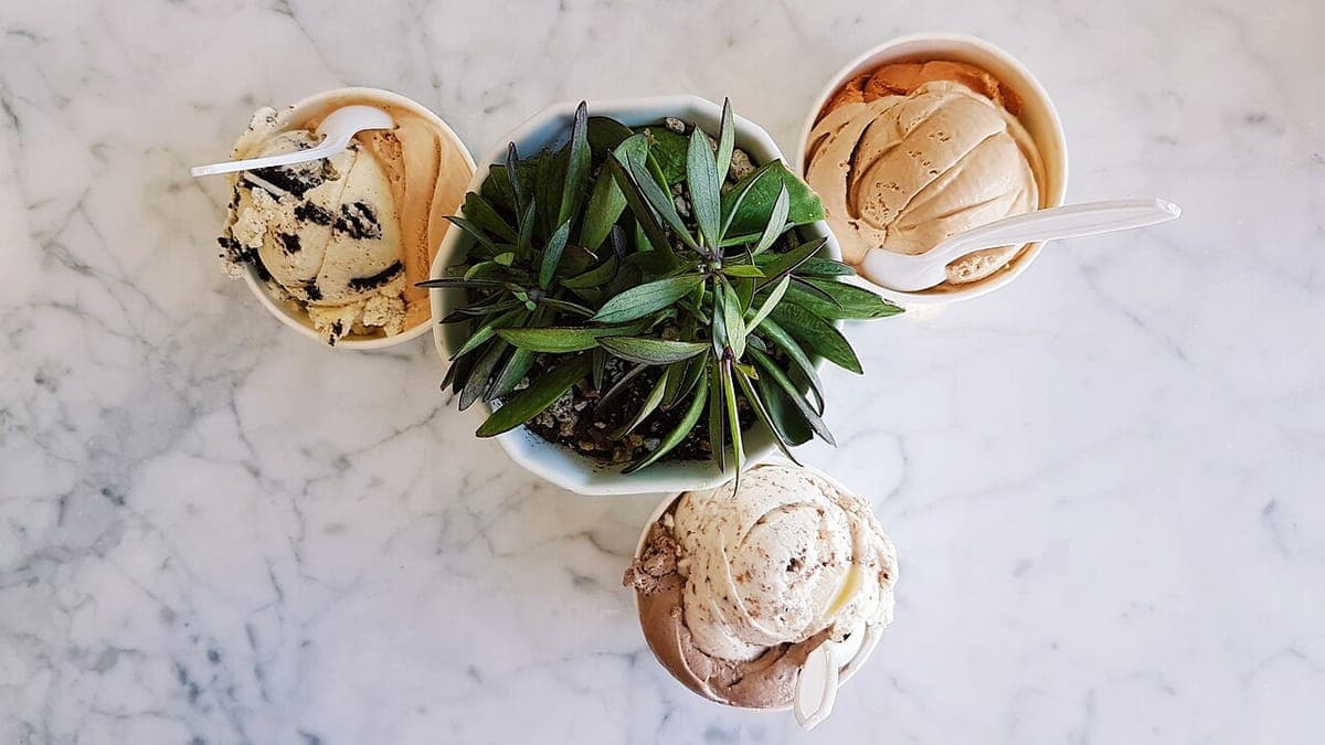 Three cups of ice cream on a marble table
