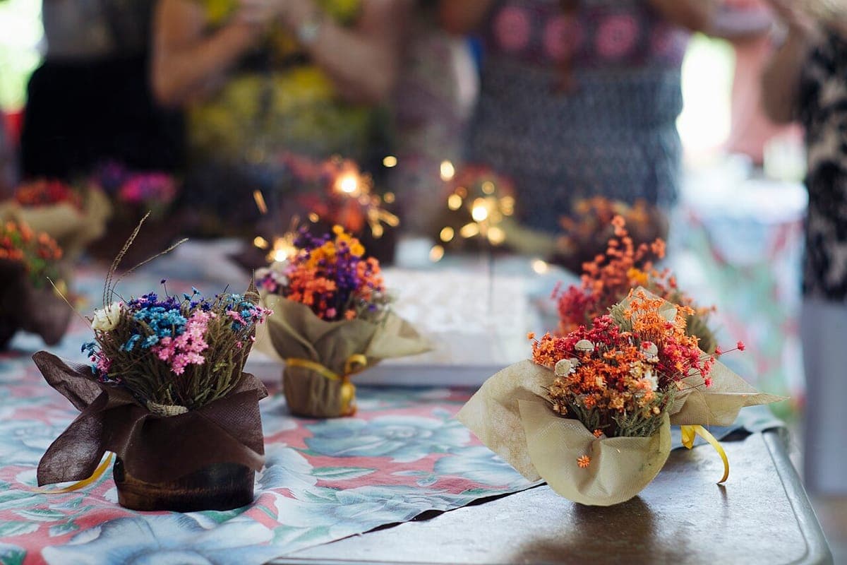 Party table set with small flower bouquets and sparklers