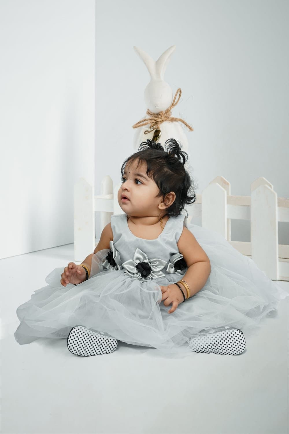 Baby girl in a grey tulle dress